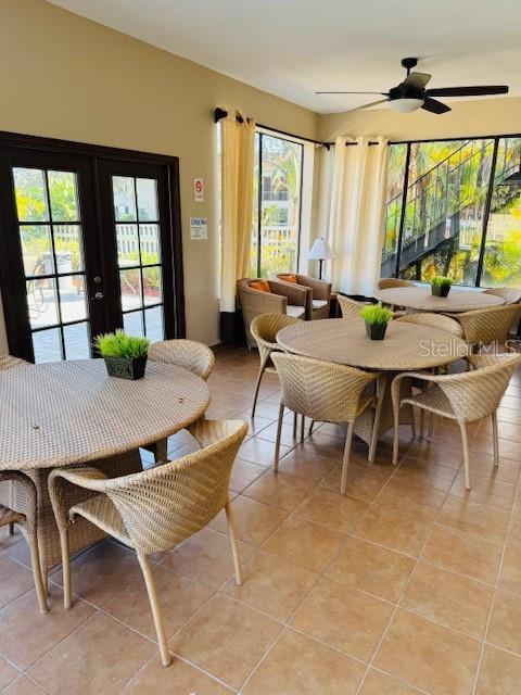 10346 Carrollwood Ln Unit 171, Tampa, FL 33618 - dining area featuring french doors, ceiling fan, and light tile patterned floors