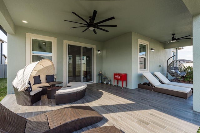 deck with outdoor lounge area and ceiling fan