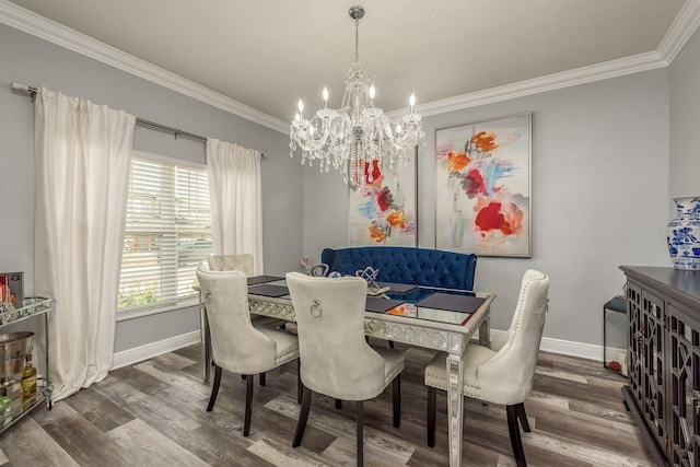 dining space with wood-type flooring, an inviting chandelier, and crown molding