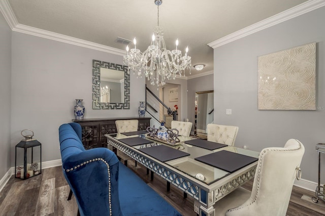 dining room with dark hardwood / wood-style flooring, crown molding, and an inviting chandelier