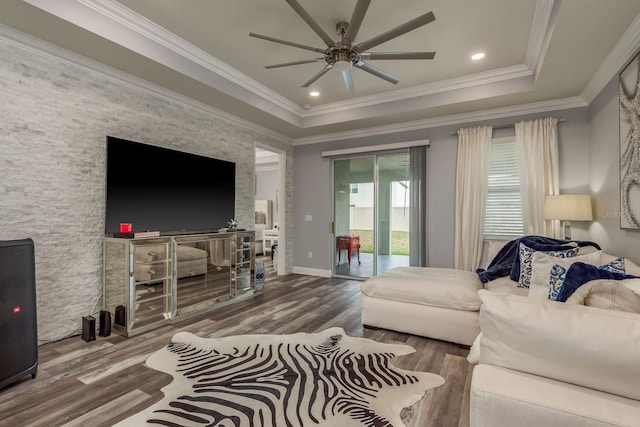 living room featuring crown molding, a tray ceiling, ceiling fan, and hardwood / wood-style flooring