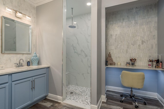 bathroom featuring a tile shower, hardwood / wood-style floors, and vanity