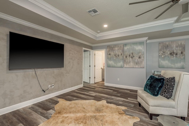 living area with crown molding, ceiling fan, a tray ceiling, and hardwood / wood-style floors