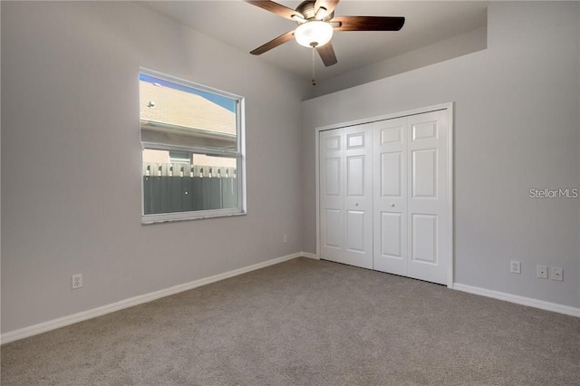 unfurnished bedroom featuring light carpet, a closet, and ceiling fan