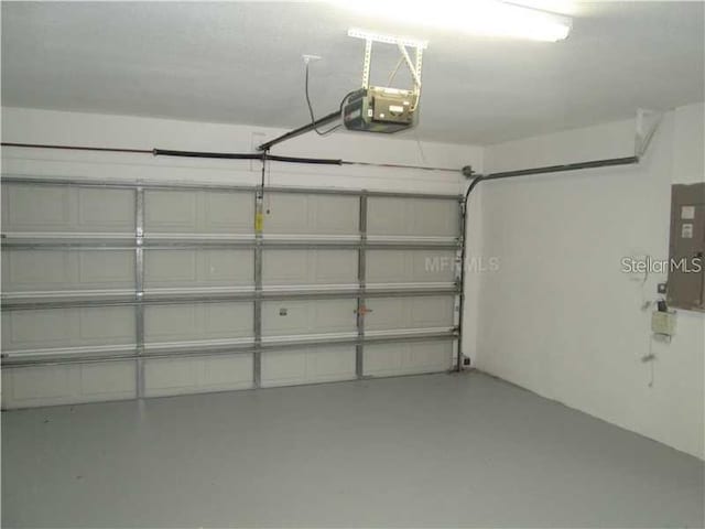 garage featuring a garage door opener and electric panel