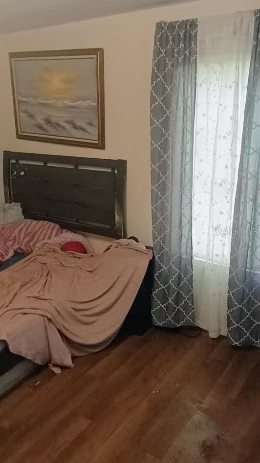 bedroom with wood-type flooring