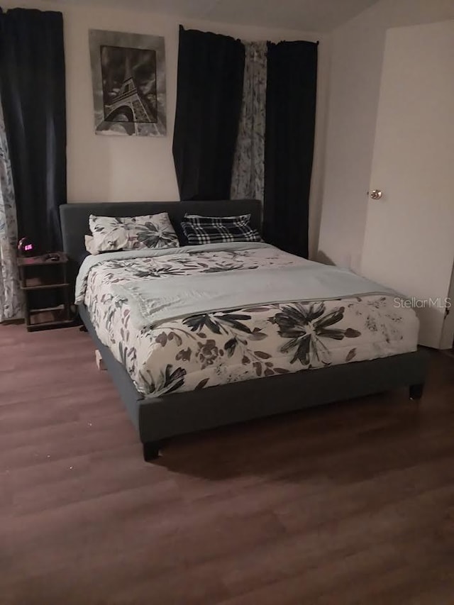 bedroom with hardwood / wood-style floors