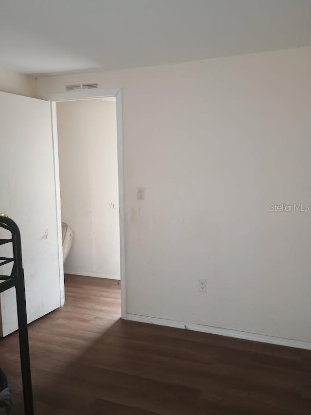 spare room featuring dark hardwood / wood-style flooring