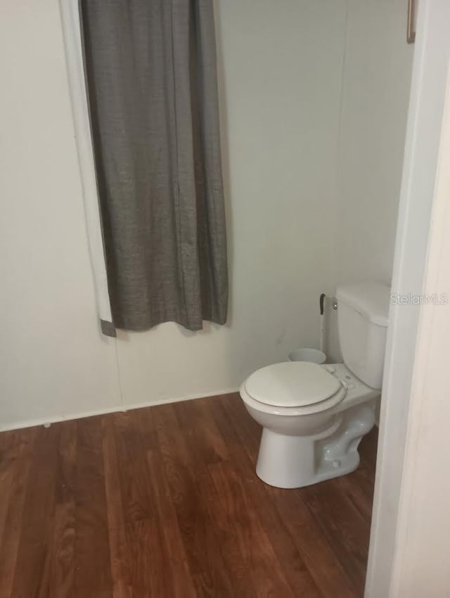 bathroom featuring toilet and hardwood / wood-style floors