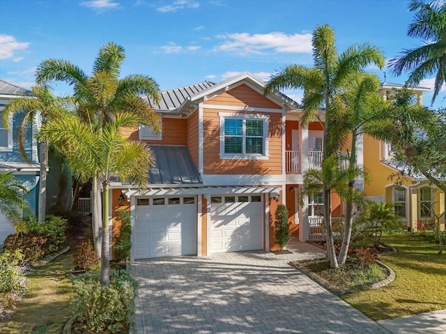 view of front of house with a garage and a balcony