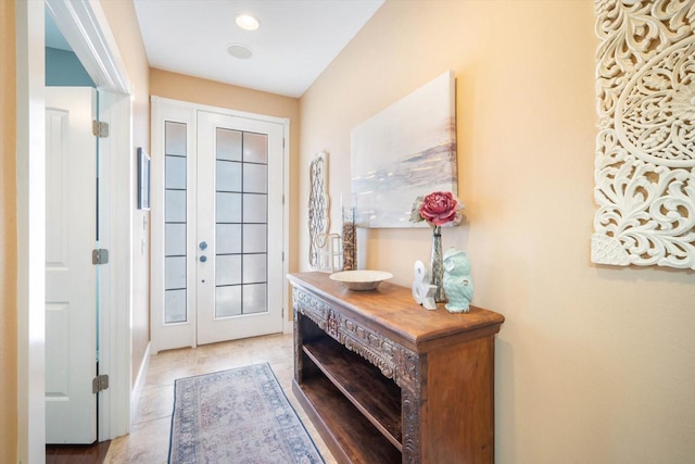 doorway to outside featuring light tile patterned flooring