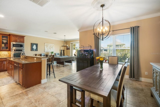 dining space featuring crown molding and a chandelier