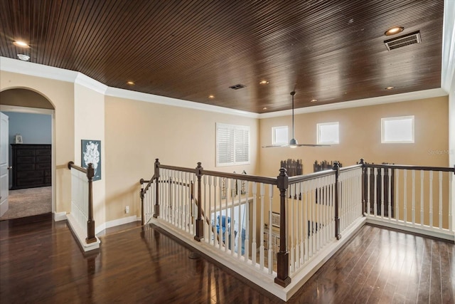 hallway featuring dark hardwood / wood-style flooring, wood ceiling, and crown molding