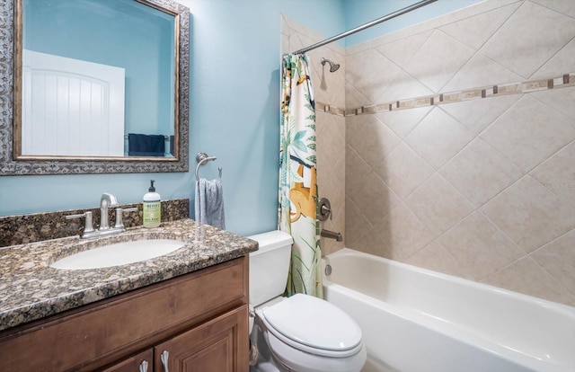 full bathroom with vanity, shower / tub combo with curtain, and toilet