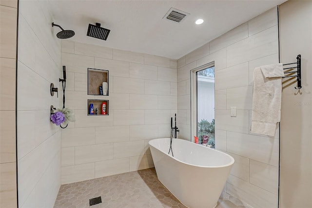 bathroom with tile walls, tile patterned flooring, and plus walk in shower