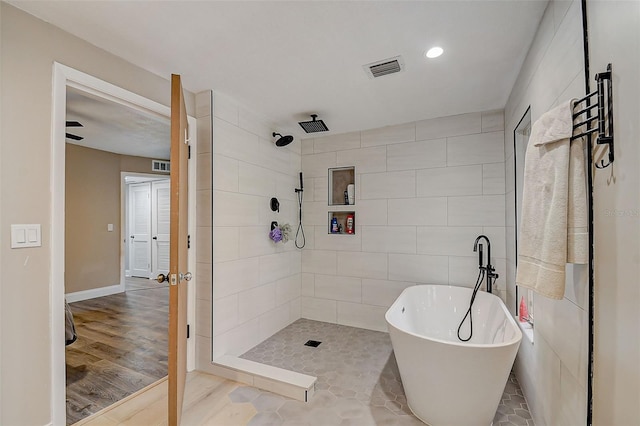 bathroom featuring wood-type flooring and plus walk in shower