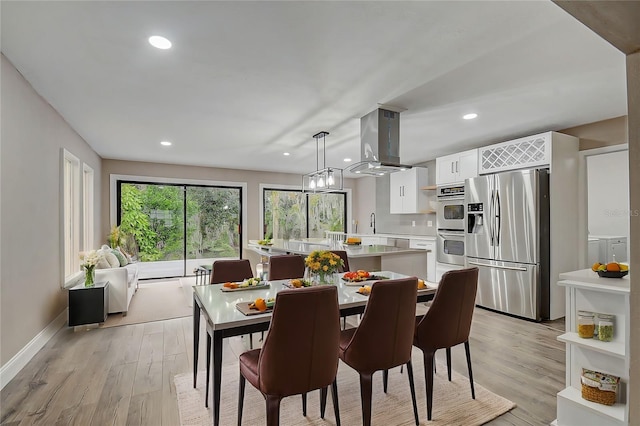 dining space with sink and light hardwood / wood-style flooring