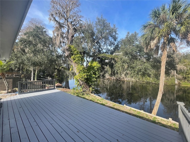 wooden terrace featuring a water view