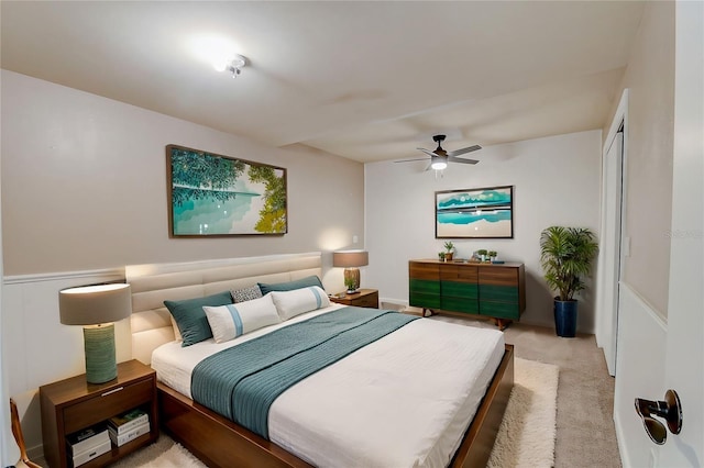 bedroom with ceiling fan and light carpet