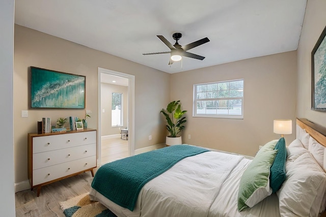 bedroom with light hardwood / wood-style floors and ceiling fan