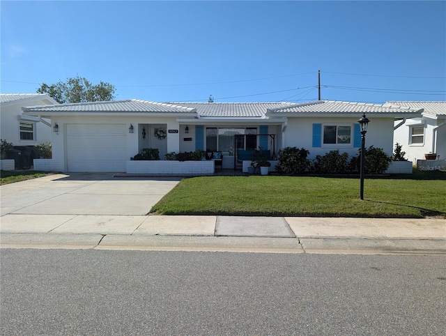 ranch-style home with a front yard, driveway, an attached garage, stucco siding, and a tile roof