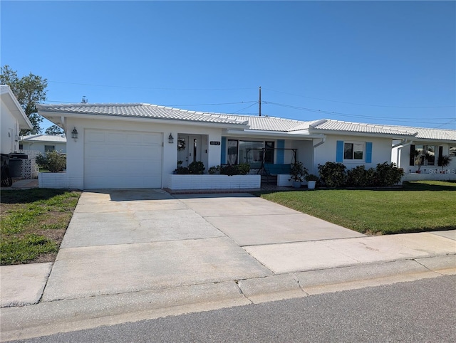 ranch-style home featuring a front yard, stucco siding, concrete driveway, a garage, and a tiled roof