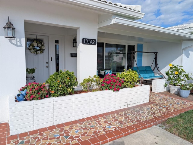 property entrance with stucco siding