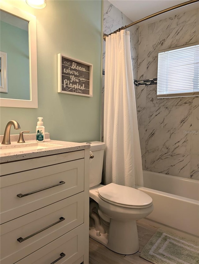 bathroom featuring toilet, shower / tub combo with curtain, and vanity