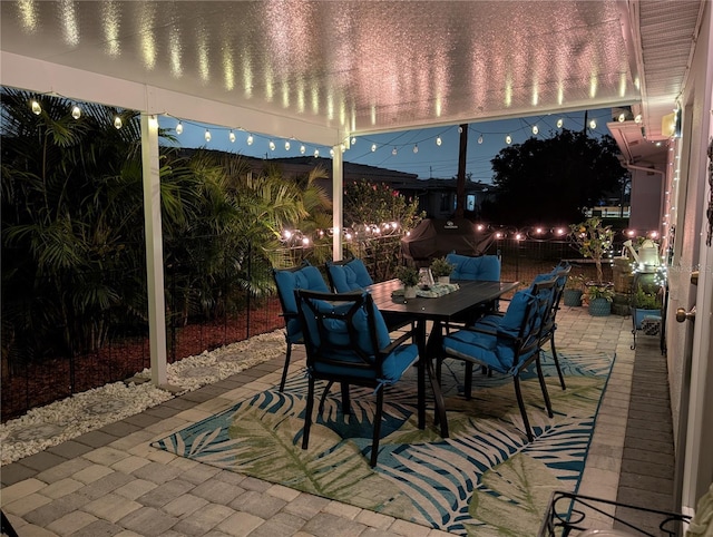 view of patio with outdoor dining area and fence