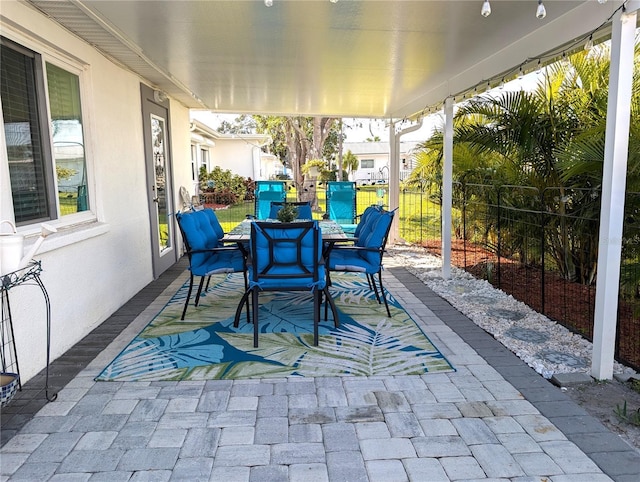 view of patio / terrace with outdoor dining space and fence