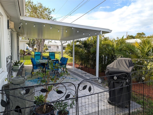 view of patio / terrace featuring outdoor dining space, fence, and grilling area