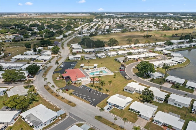 drone / aerial view with a residential view and a water view