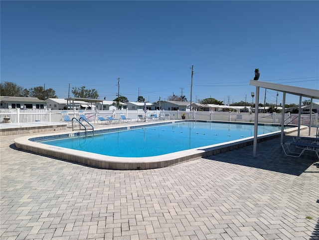 community pool featuring a patio area and fence