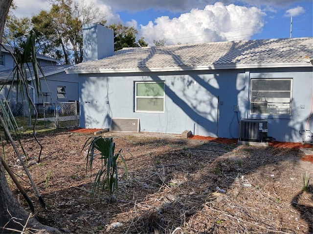 back of house featuring central air condition unit