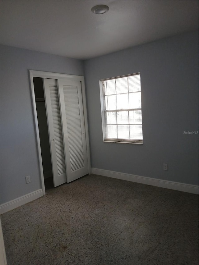 unfurnished bedroom with a closet