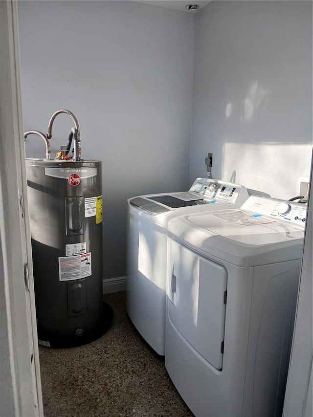 washroom with washer and clothes dryer and water heater