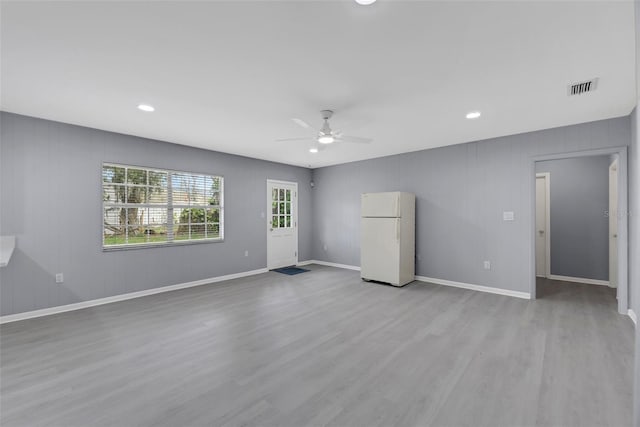 unfurnished living room featuring light hardwood / wood-style floors and ceiling fan