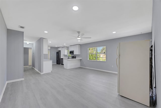 unfurnished living room with light wood-type flooring and ceiling fan