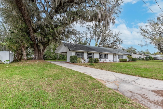 ranch-style house with a carport and a front lawn