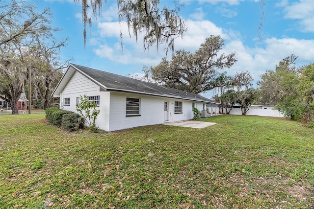 back of house featuring a patio area, central AC unit, and a lawn