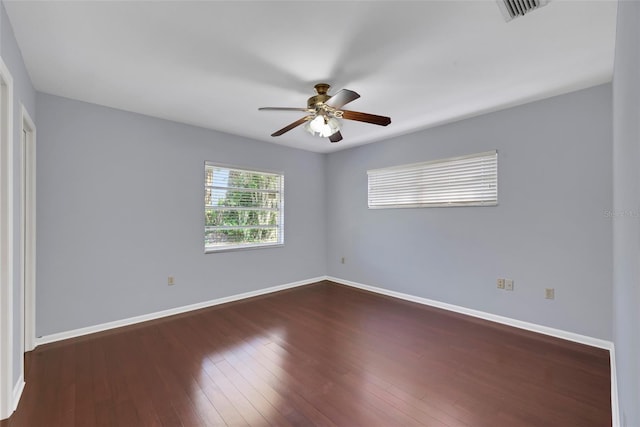 unfurnished room with dark wood-type flooring and ceiling fan