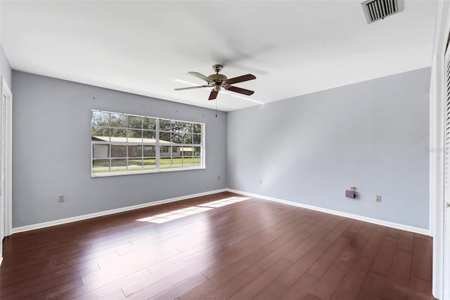 empty room featuring ceiling fan and dark wood-type flooring