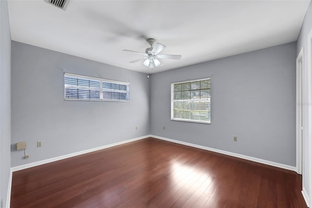 unfurnished room with ceiling fan and dark hardwood / wood-style flooring