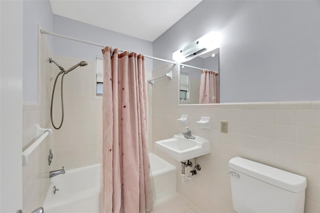 bathroom featuring shower / tub combo with curtain, toilet, and tile walls