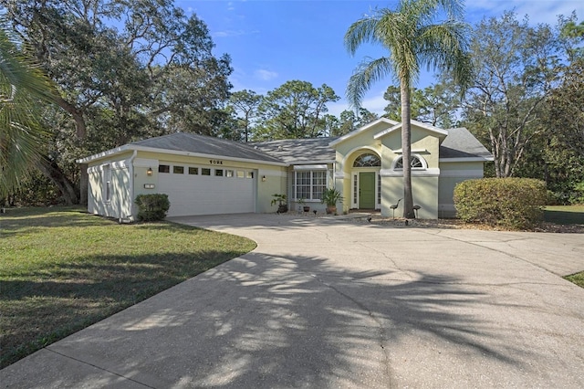 ranch-style house featuring a garage and a front lawn