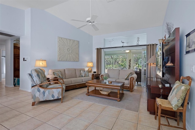 tiled living room with ceiling fan and high vaulted ceiling