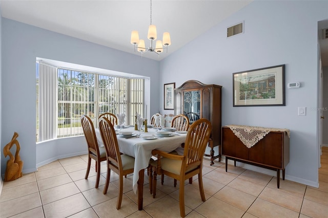 dining space featuring light tile patterned floors, vaulted ceiling, and a chandelier