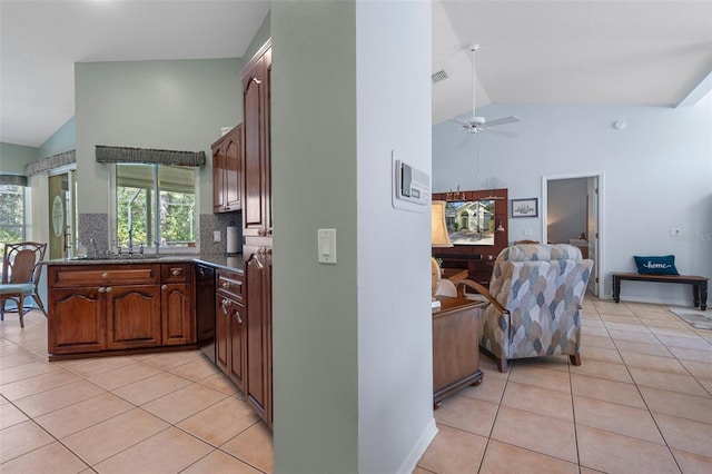 kitchen with light tile patterned flooring, dishwasher, backsplash, and kitchen peninsula