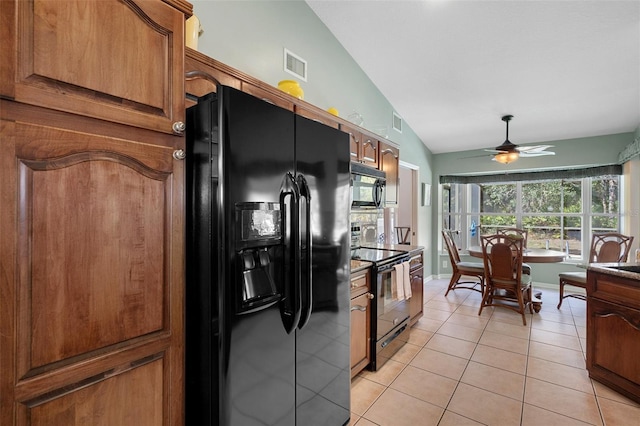 kitchen featuring light tile patterned floors, vaulted ceiling, black appliances, and ceiling fan