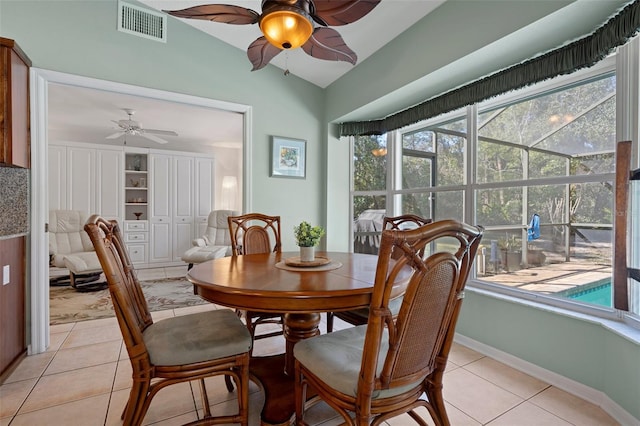 tiled dining room featuring lofted ceiling and ceiling fan